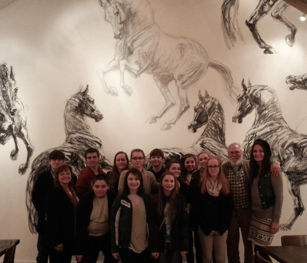 Students pose for a photo with noted French artist Jean-Louis Savaut at the White Horse in Metamora. From the left to right  front row – Madame Clem, Kole Klebba, Madeline Melo Lily, Bourret, Hanna Schlaud,  back row – Brent Walker, Brendan Hall, Lyndsay Stickley, Merideth DeWitte, Joe Shultz, Katie Gariglio, Brooklyn George, Brianna George, Jean-Louis Sauvat, Madame Newton. 
